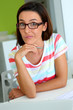 Upset girl with eyeglasses working on laptop