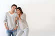 Young couple standing on white background
