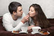 man feeding woman