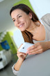 Young woman using smartphone at home