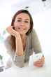 Young woman using smartphone at home