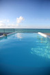 Closeup of infinity pool getting to the sea