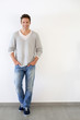 Handsome relaxed guy standing on white backgroud