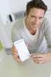 Closeup on smartphone screen held by man's hand