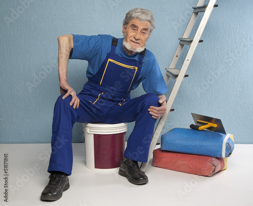 Photo: old master plasterer sitting on a bucket of paint old master plasterer sitting on a bucket of paint