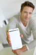 Closeup on smartphone screen held by man's hand