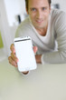Photo: Closeup on smartphone screen held by man's hand Closeup on smartphone screen held by man's hand