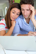 Photo: Couple looking at bank account on laptop Couple looking at bank account on laptop