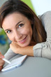 Young woman using smartphone at home
