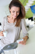 Young woman at home connected on smartphone