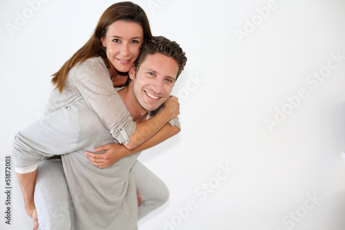 Photo: Handsome guy giving piggyback ride to girlfriend Handsome guy giving piggyback ride to girlfriend