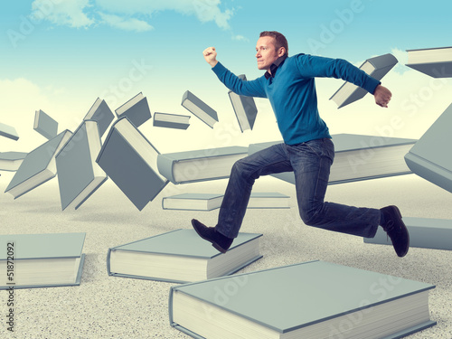 Photo: man on books man on books