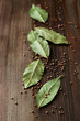 Bay leaves and mustard seeds on wooden background