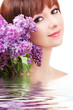 Young woman with lilac flowers