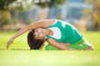 Foto: Pretty woman doing yoga exercises in the park Pretty woman doing yoga exercises in the park