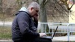 Man with cell phone and  PC at outdoor