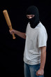 Masked man preparing to attack with bat