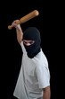 Masked man aims and attack with bat