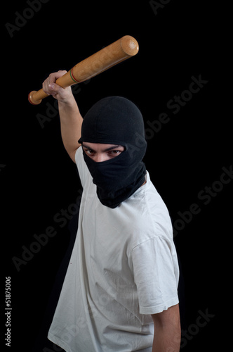 Photo: Masked man aims and attack with bat Masked man aims and attack with bat