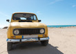 Foto: Yellow retro car by the sea Yellow retro car by the sea