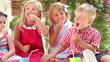 Children Enjoying Food At Party