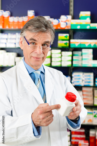 Photo: Pharmacist in pharmacy with medicament Pharmacist in pharmacy with medicament