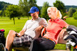 Young sportive couple playing golf on a course