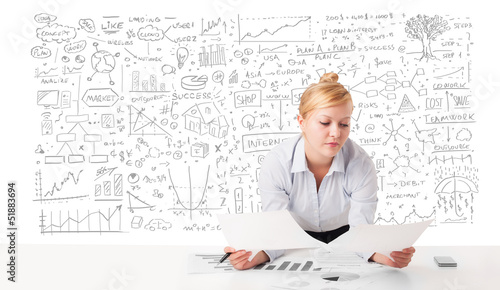 Photo: Pretty businesswoman planning and calculating various business i Pretty businesswoman planning and calculating various business i