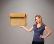 Young woman holding an empty cardboard box