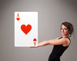 Beautifu woman holding a red heart ace