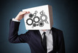 Businessman gesturing with a cardboard box on his head with spur
