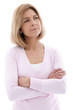 Pensive woman standing with folded arms