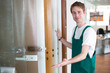 Glazier presenting glass doors in showroom