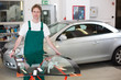 Glazier in garage handling a windscreen made of glass