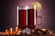 mulled wine in the glasses, spice and lemon on purple