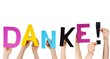 people holding word DANKE!