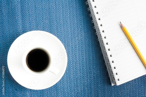 Photo: cup of black coffee with notepad cup of black coffee with notepad