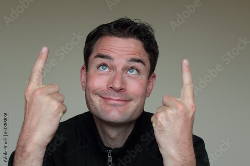 Photo: Handsome caucasian man pointing up with both hands Handsome caucasian man pointing up with both hands