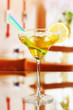Yellow cocktail in glass on room background