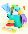 Cleaning items in bucket on  white wooden background