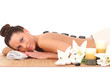 Foto: Beautiful relaxing woman with stones on her back in a Spa Beautiful relaxing woman with stones on her back in a Spa