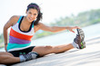Athletic woman doing stretching exercises