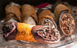 Assorted cannoli of different flavors on a fancy plate
