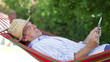 Video: Senior Man In Hammock Using Tablet Computer Senior Man In Hammock Using Tablet Computer