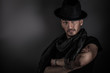 Photo: handsome young guy posing with hat, on blue bagkground handsome young guy posing with hat, on blue bagkground