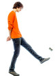 Photo: young man walking kicking tin can side view young man walking kicking tin can side view