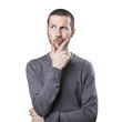 Portrait of handsome young thoughtful man isolated over white ba