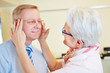 Man testing rimless glasses at optician