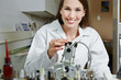 Woman in workshop using drilling machine