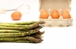 Asparagus and eggs on white background